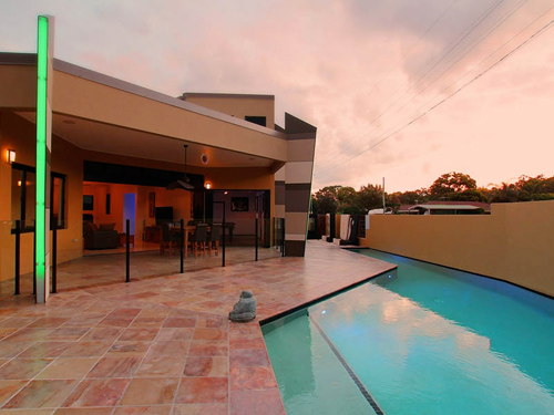 large house with swimming pool at sunset