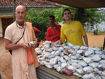 The traveling monk, Indradyumna Swami and Paul handing out hot packaged meals in Sri Lanka. 