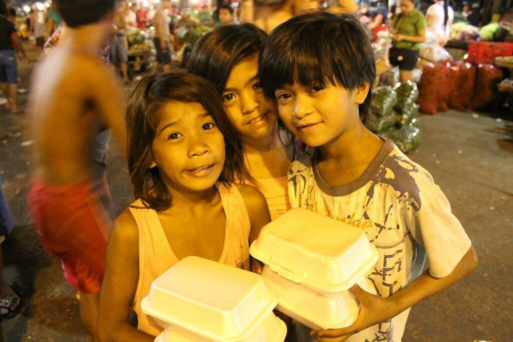 Poor children with food in the boxes