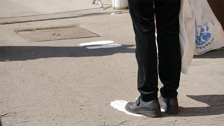 Printed footprints ensure prasadam recipients maintain the right amount of social distance when in line