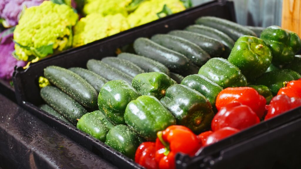 bell peppers and zucchinis in a black tray