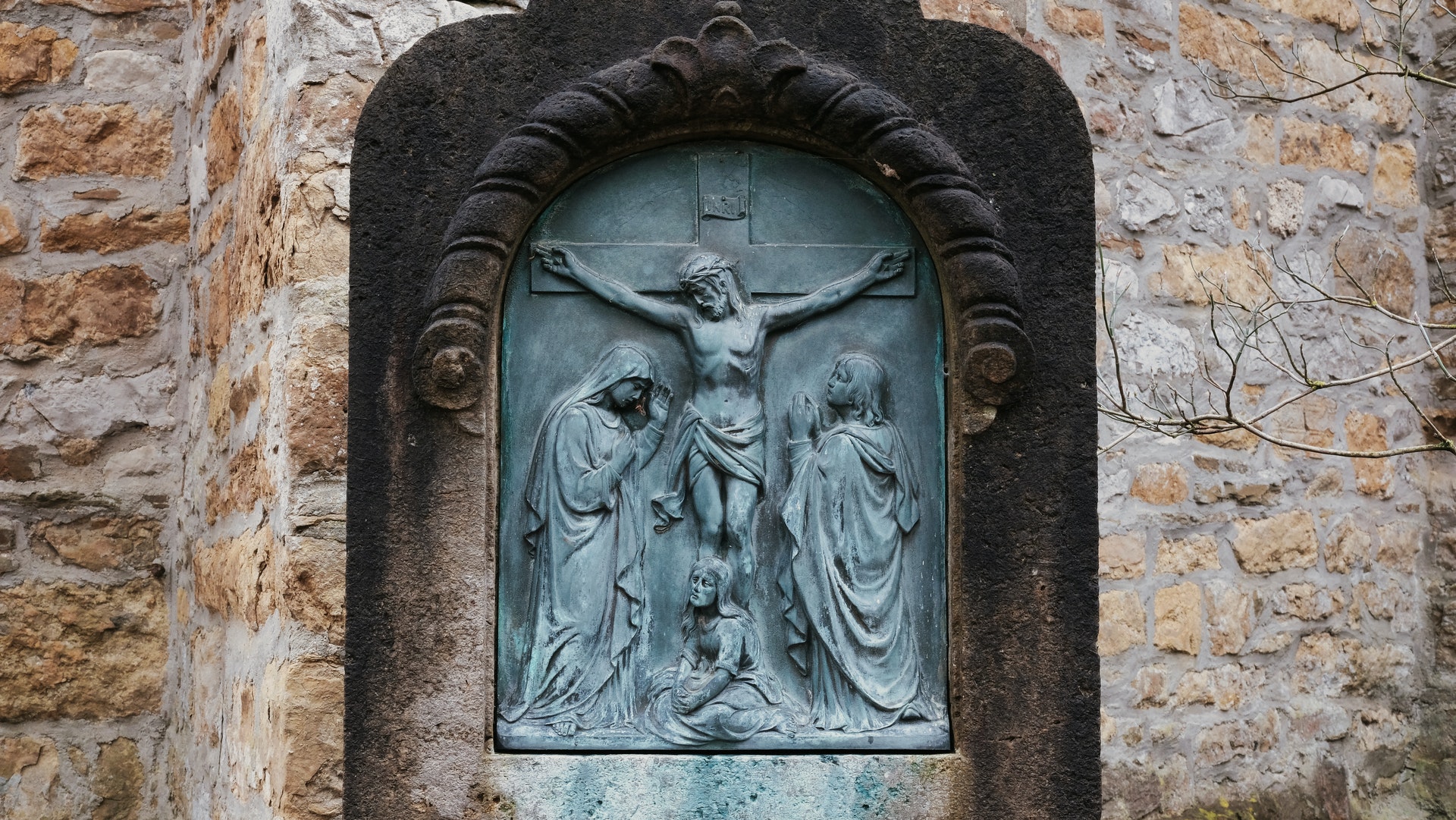 A closeup of sculpted imagery of Jesus Christ on the Cross