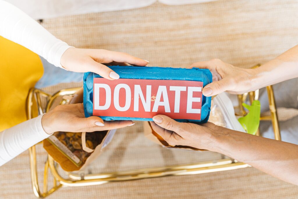 Two person holding donation card