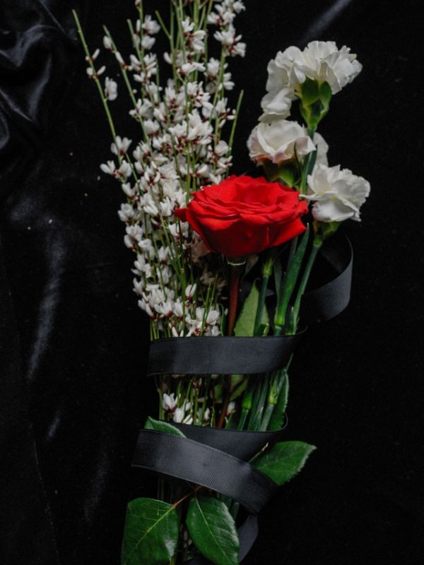memorial flowers on a black surface