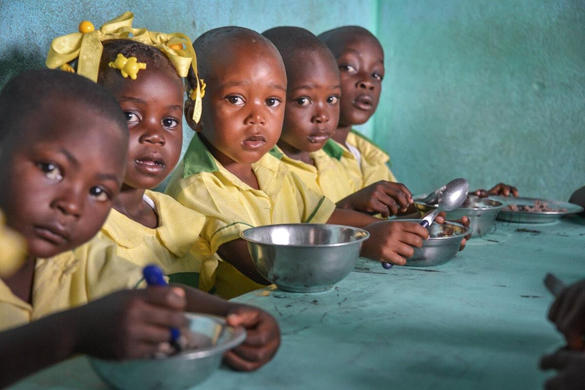 Hungry children eating the food
